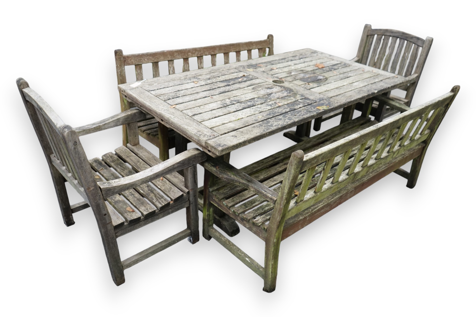 A weathered teak extending garden table, with pair of matching slatted benches and two elbow chairs